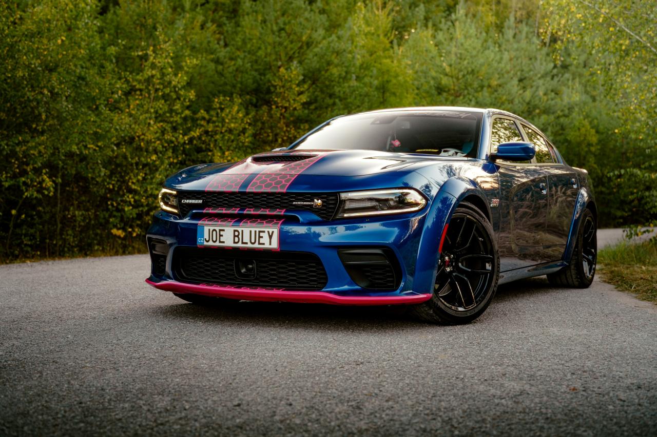 A blue car parked on the side of a road